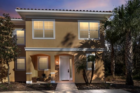 Welcome to this charming vacation home, where warm tones and inviting lighting create a cozy atmosphere. Experience the tropical vibe of palm trees and beautifully landscaped surroundings, perfect for your relaxation and comfort.
