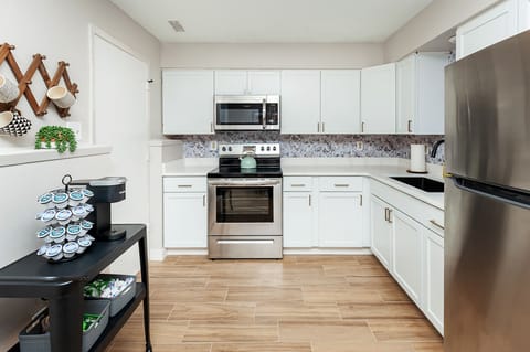 Adorable kitchen with floral print accents.