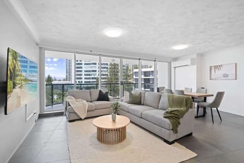 Enjoy a spacious living room adorned with two couches and abundant natural light.