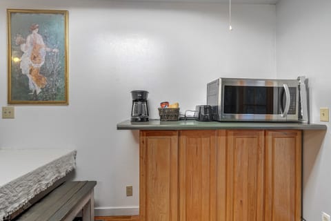 Across the kitchen, you'll find a coffee maker for your morning brew and the microwave.