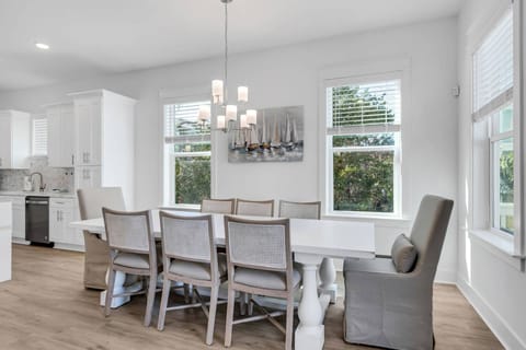 The dining area features a large farmhouse style table with comfortable seating for 8, and additional seating for 4 at the expansive kitchen island!