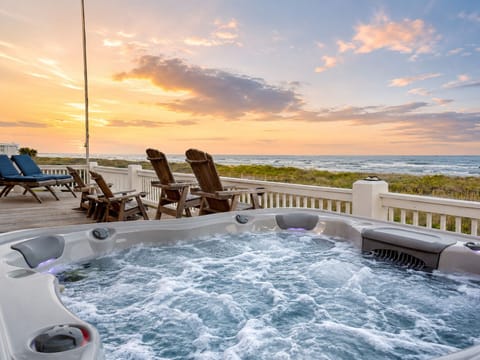 Private hot tub overlooking the Gulf of Mexico at sunset, with bubbling water, beachfront views and comfortable deck seating at this Bolivar Peninsula vacation rental.