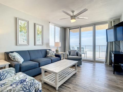Cozy living room with comfortable seating, large windows, and beautiful ocean views.