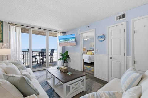Bright beachfront condo featuring ocean views, private balcony, and coastal décor. Enjoy your beach stay with direct shoreline access, airy living space, and relaxing vibes just steps from the sand.