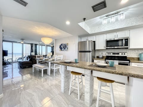 Modern kitchen featuring a breakfast bar, perfect for casual dining and entertaining with ocean views nearby.
Image 23