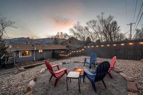 Cozy fire pit area with Adirondack seating and mountain views—perfect for evening relaxation under the string lights.

