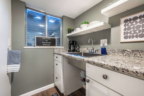 Compact yet efficient, the kitchenette offers everything you need for light meals—featuring a granite countertop, microwave, mini fridge, Keurig coffee maker, and open shelving stocked with essentials.







