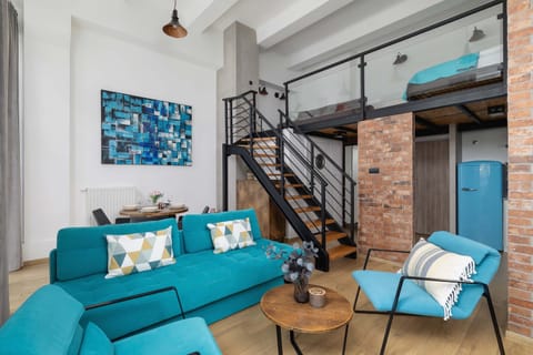 Stylish living area with double sofa bed, coffee table, dining area and mezzanine.