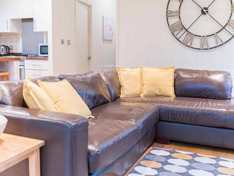 Open plan lounge/diner/kitchen with Smart TV and wood burner