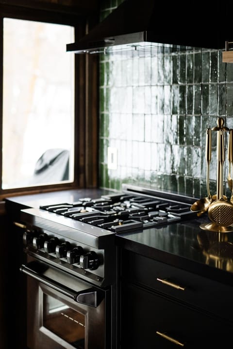 High-end gas stove with Moroccan-tile backsplash