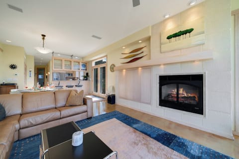 Living room with gas fireplace, Direct TV, Ocean views, Surround sound, Overhead fans, open to dining area.
