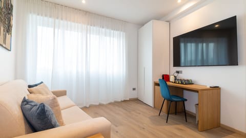 Deluxe Quadruple Room | Down comforters, memory foam beds, in-room safe, individually furnished