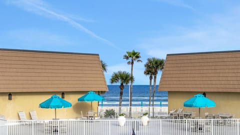 Oceanfront patio with vibrant umbrellas and pool access