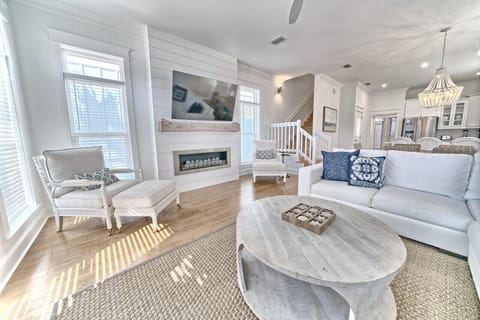 Relax in style with our sun-drenched living room that combines modern comfort with a touch of coastal elegance. Enjoy the designer furnishings, and the inviting open floor plan—perfect for your beach getaway!