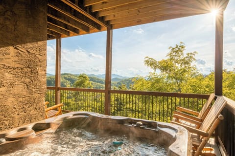 Unwind in your private hot tub on the covered deck as you soak in breathtaking mountain vistas under warm sunlight and open skies.