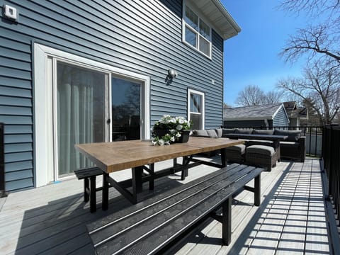 Deck w/ seating for 14. Covered garage visible.