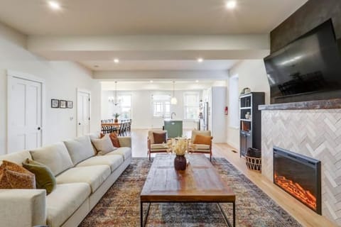 Large open floor plan with living room, kitchen, and dining area. 
