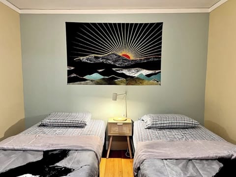 A bright and inviting bedroom featuring two cozy beds—ideal for friends, kids, or extra guests. 