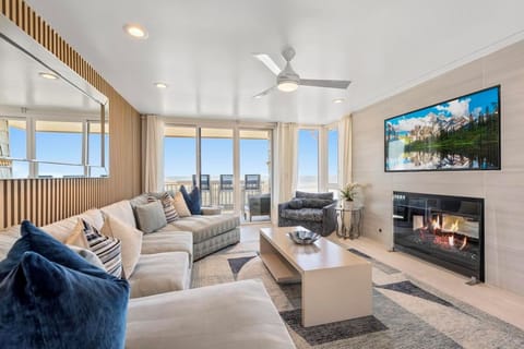 Cozy up by the fireplace in a living space that harmonizes luxury and comfort