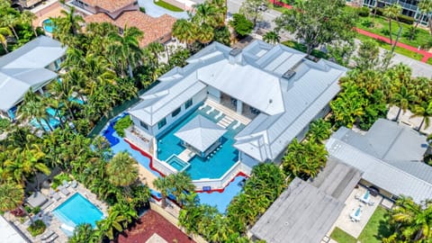 Welcome to Dream Island! A beautifully designed estate unfolds from above, showcasing its expansive layout and resort-style pool.