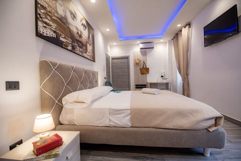 Deluxe Quadruple Room | Memory foam beds, in-room safe, desk, blackout drapes