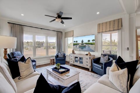 - Bright and stylish living room with panoramic windows and serene outdoor views - Sink into plush seating, catch a movie on the big screen, or simply relax in the sunlit calm - Coastal inspired decor and cozy touches make this the heart of your stay