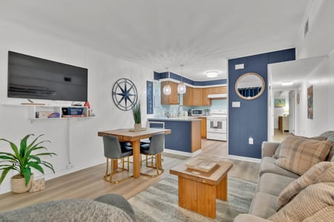 Living Room with luxury vinyl plank flooring, TV, & Dining Area for 4.