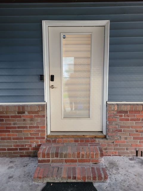 Side door entry under the carport with code enable smart lock.  