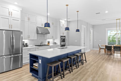 Kitchen features an island with barstool seating.