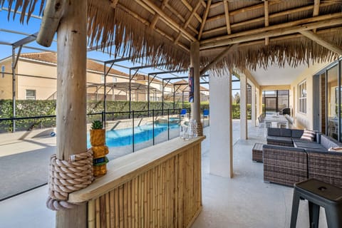 - Screened private pool with tiki bar and outdoor lounge seating  
- Relax on shaded patio with comfortable rattan furniture set  
- Vacation rental with poolside fun near Disney Orlando parks
- This property no longer has a grill
