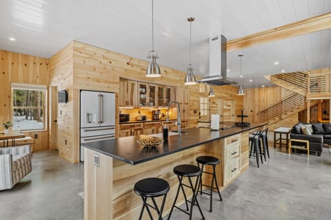 The kitchen is open to the living and dining space and features a breakfast nook.