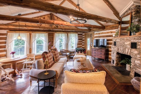 Relax in our cozy living room, decorated with rustic Americana charm and a warm stone fireplace. (1)