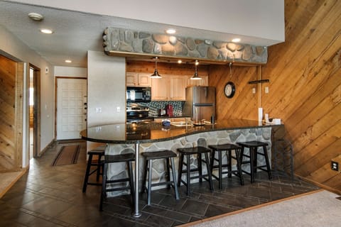 Roomy Kitchen with Six Barstools for Eating. 
