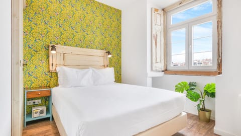 A comfortable bedroom with a city view, a TV, and a safe lock to keep your items safe. #comfort #cityview #safelock #portugal #pt #lisbon
