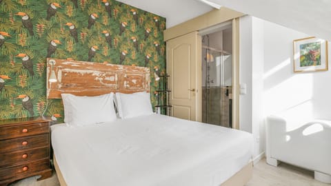 Unwind in this bedroom is adorned with vibrant wallpaper and repurposed classical furniture. #decoration #lisbon #vacations #airbnb