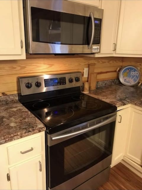 Electric range and Microwave.  Fully stocked kitchen 