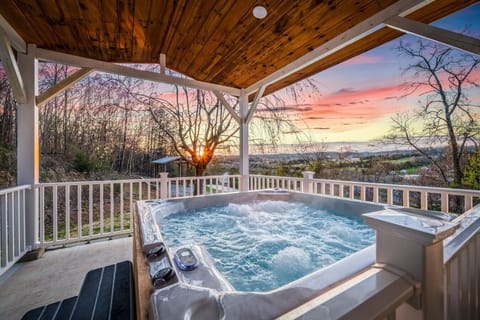 Beautiful bubbling hot tub is located just off the side of the house and is covered.