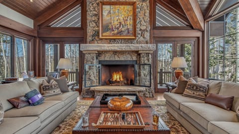 Great Room, Main Level - Soaring ceilings, stone gas fireplace, and ample seating with mountain views