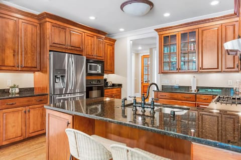 Fully equipped kitchen with fridge, oven, and storage.