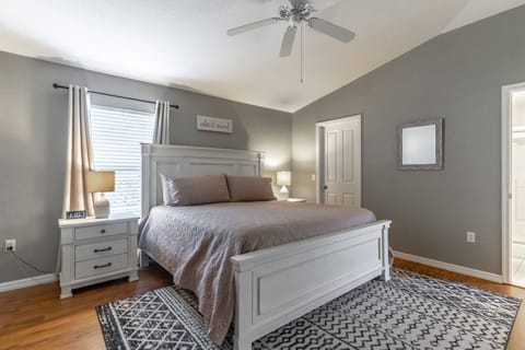 Cozy master bedroom with hardwood floors and King Sized bed