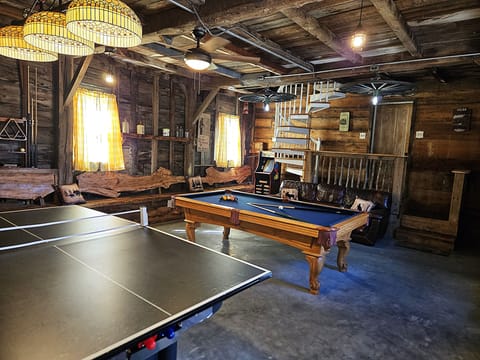 Large game room with pool table, ping pong, air hocky, packman, spiral staircase