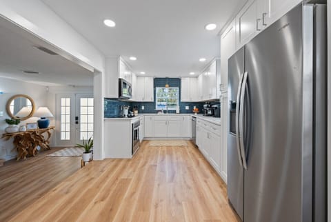 Open kitchen with chef cookware and new appliances