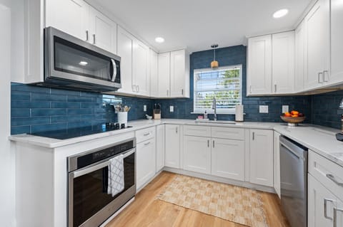 Open kitchen with chef cookware and new appliances