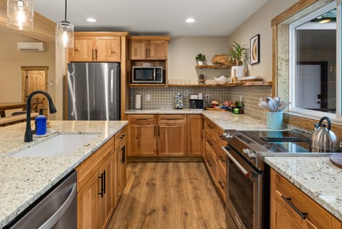 Kitchen with refrigerator, microwave, dishwasher, Keurig K-Duo, convection oven and range. 