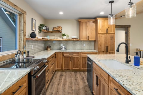 Kitchen with refrigerator, microwave, dishwasher, Keurig K-Duo, convection oven and range. Also features a tall pantry cabinet for you to put your food items when you arrive.