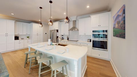 High-end appliances, sleek countertops, and ample cabinetry make this kitchen perfect for family meals and entertaining.