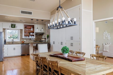 Enjoy memorable dining experiences in the welcoming ambiance of the dining area, featuring a beautiful wood table, stylish chairs, and plenty of natural light.