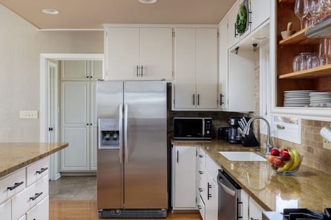 Prepare delicious meals with ease in the fully equipped gourmet kitchen, featuring all-new stainless steel appliances, ample counter space, and modern amenities