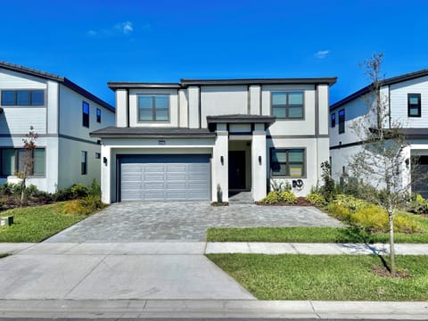 Entrance to the house with landscaping and trees