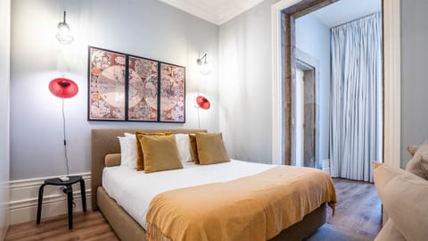 Relax in this tranquil bedroom, where the soft bedding and gentle lighting create a perfect ambiance for unwinding after a day of exploration, with easy access to other areas of the apartment.